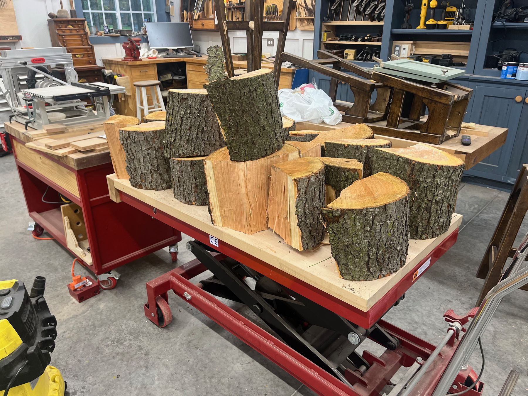 Log rounds on a lift cart, waiting to be turned into bowls