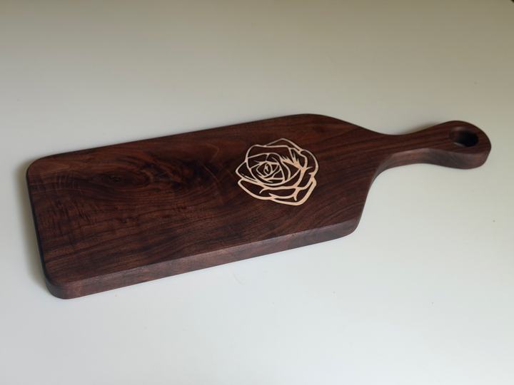 Walnut serving board with a maple rose inlay